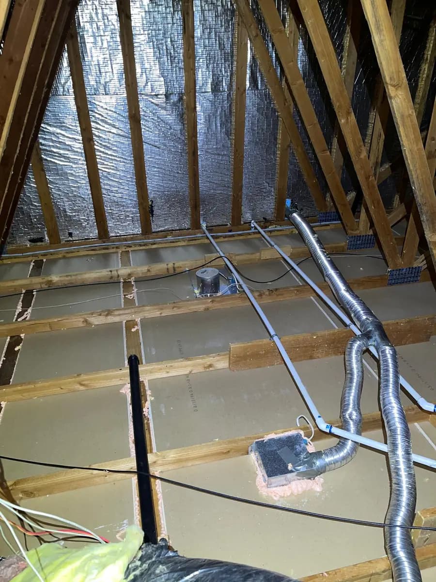 Cleared attic with sealant applied around each ceiling penetration, including electrical boxes, pipes and duct openings.